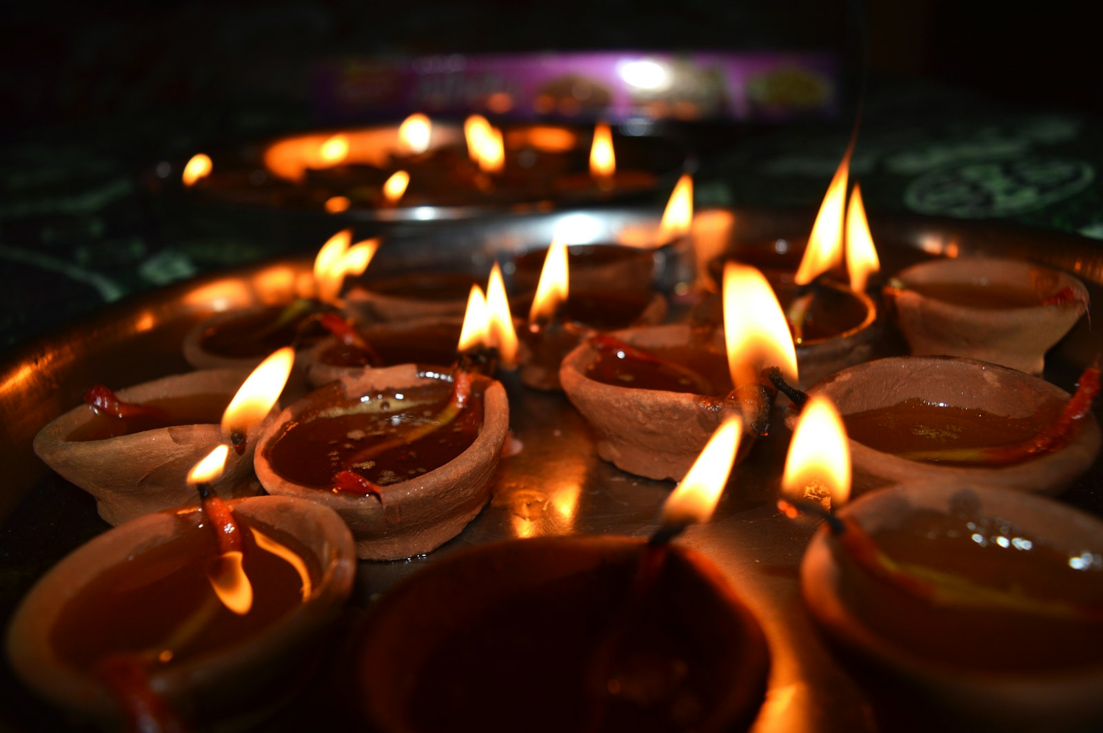 Lit diya oil lamps glowing in the dark